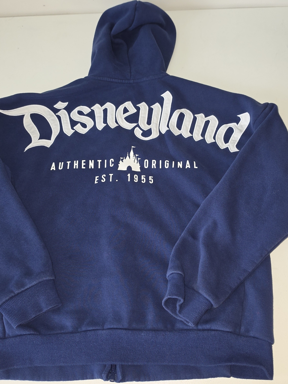 Blue Disneyland Parks Authentic Original Est. 1955 zip-front hoodie sweatshirt.